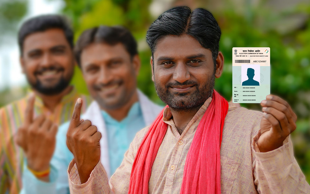 Indian voters in a queue displaying voter identity cards